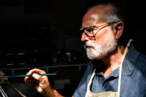Portrait of Artist Brian Davey painting in his studio